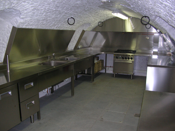 oude kelderkeuken met oven, afwasbak en koelkasten